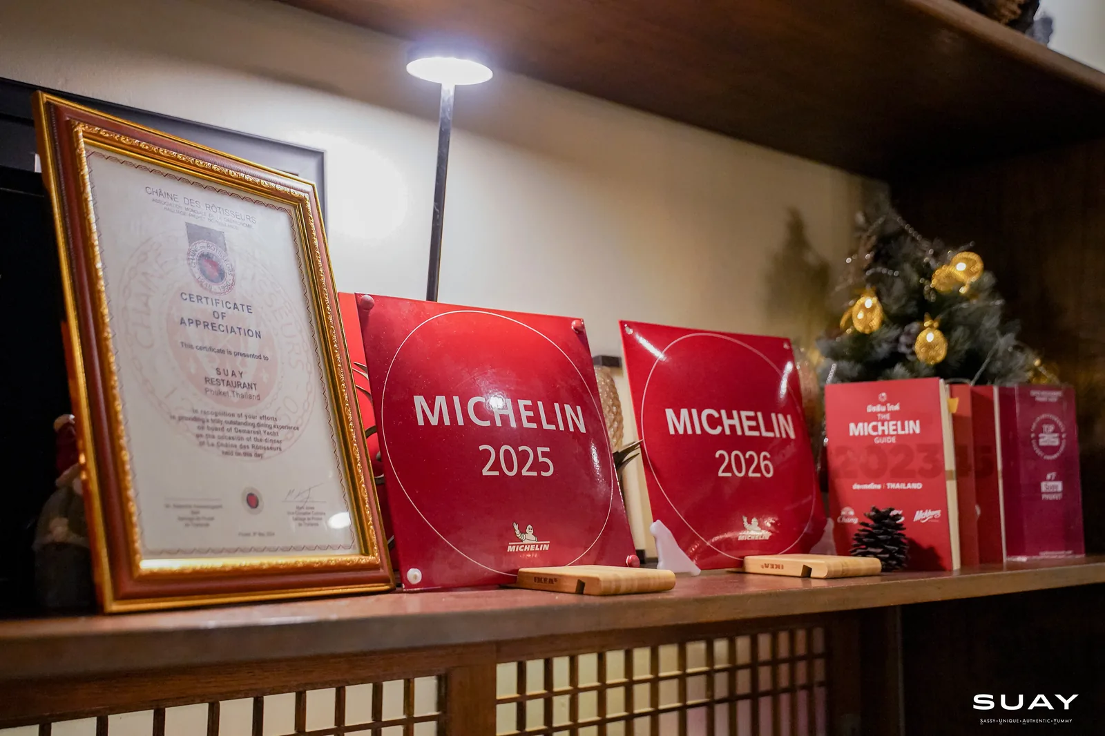 Michelin Guide plaques 2025 and 2026 on the shelf