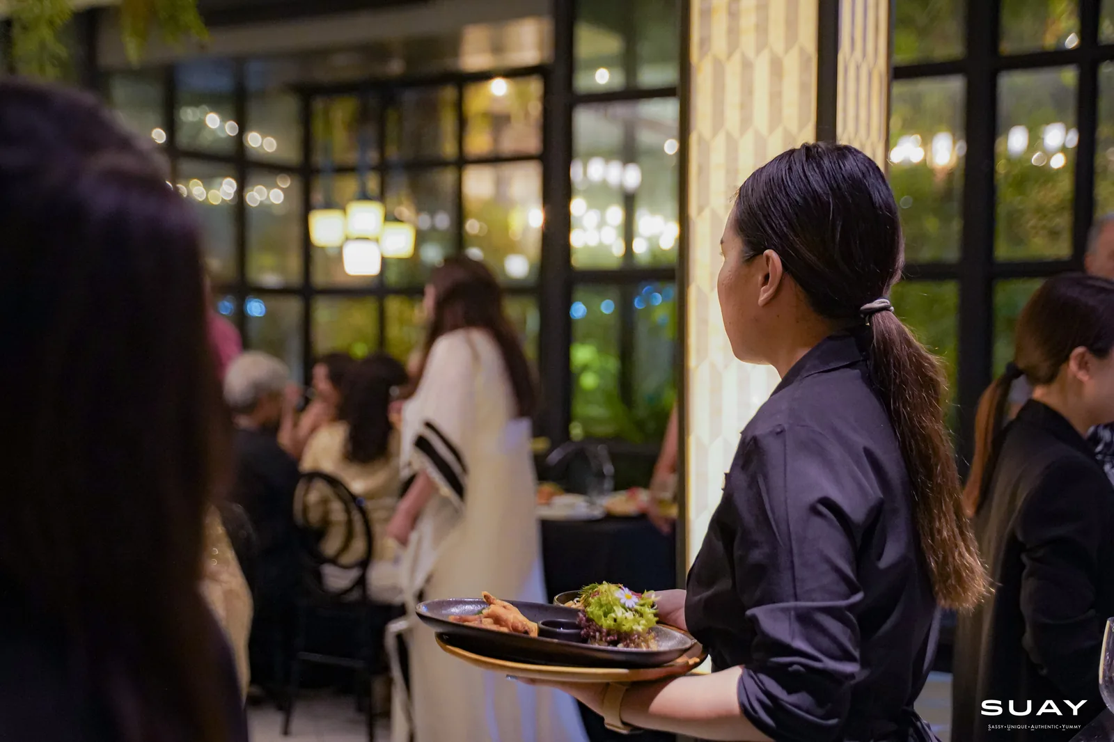 A server carrying a duck dish
